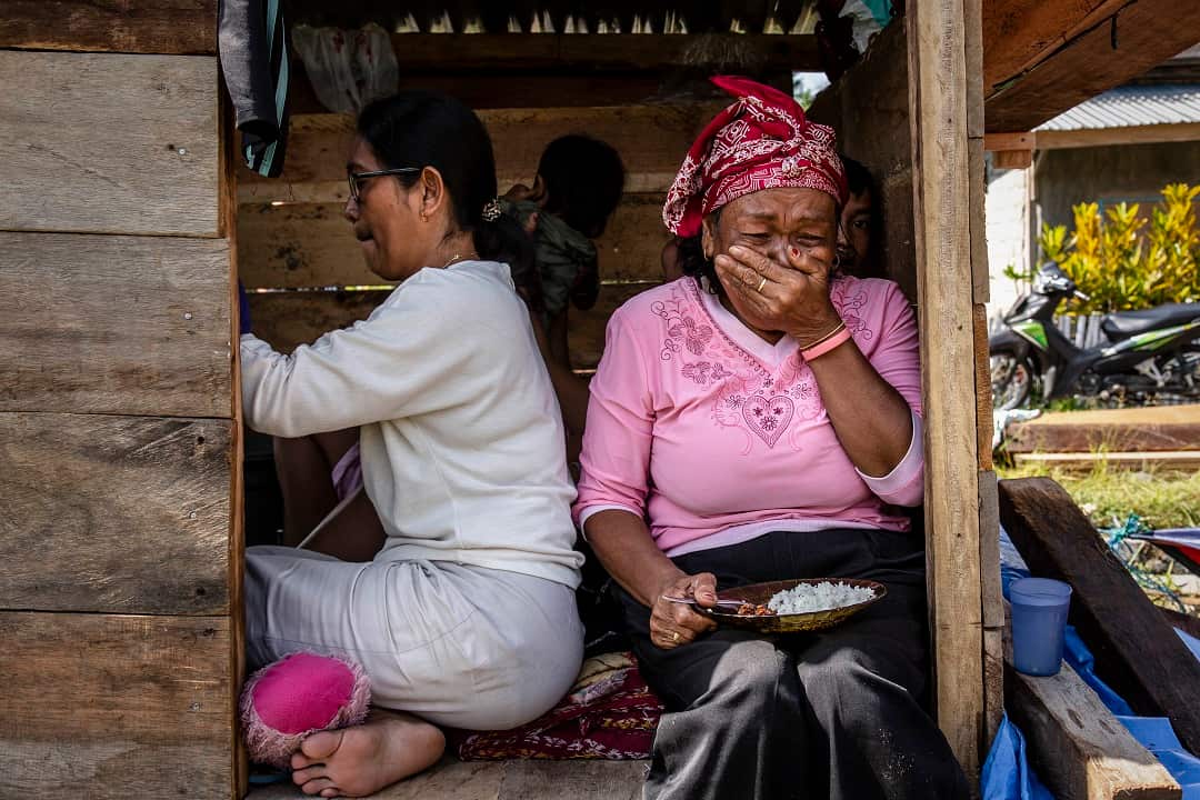 A woman in her makeshift tent in the isolated village of Kulawi.