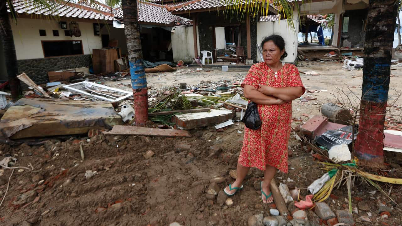 A Tsunami survivor, Sumiati, stands among debris in a devastated area after a tsunami hit Sunda Strait in Carita, Banten, Indonesia, 26 December 2018.  