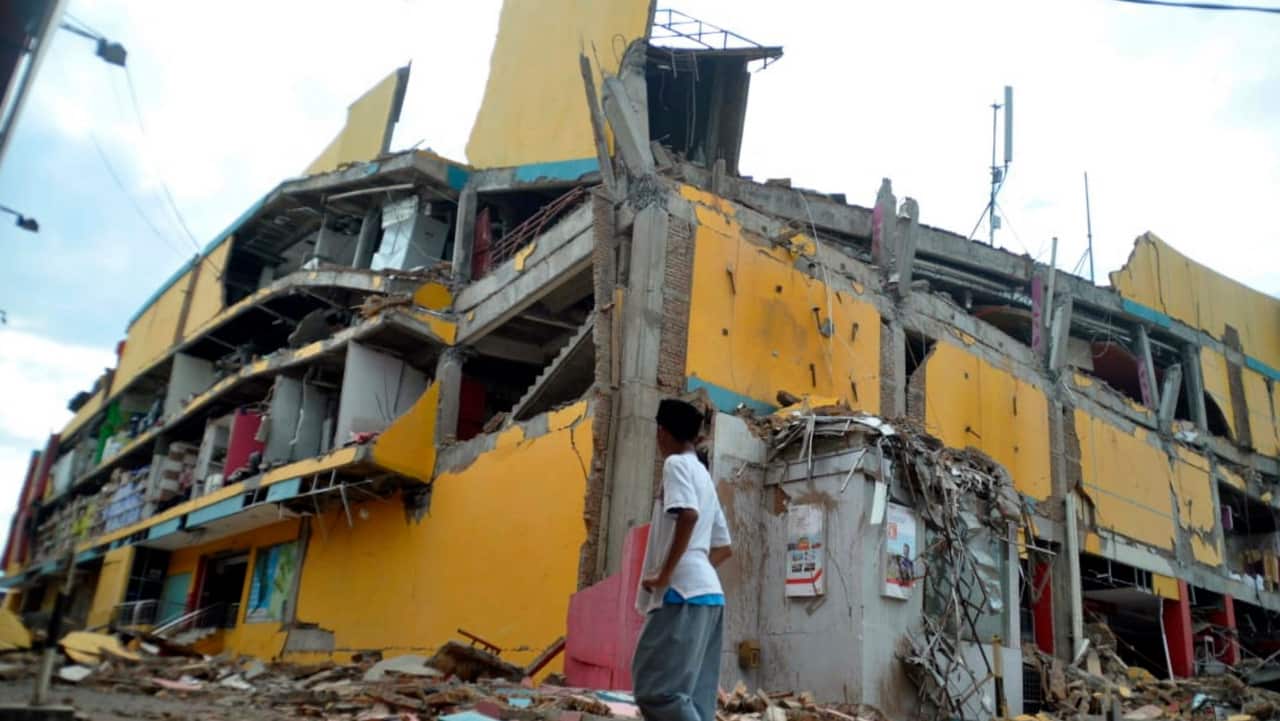 A man surveys the damage following earthquakes and a tsunami in Palu, Central Sulawesi.