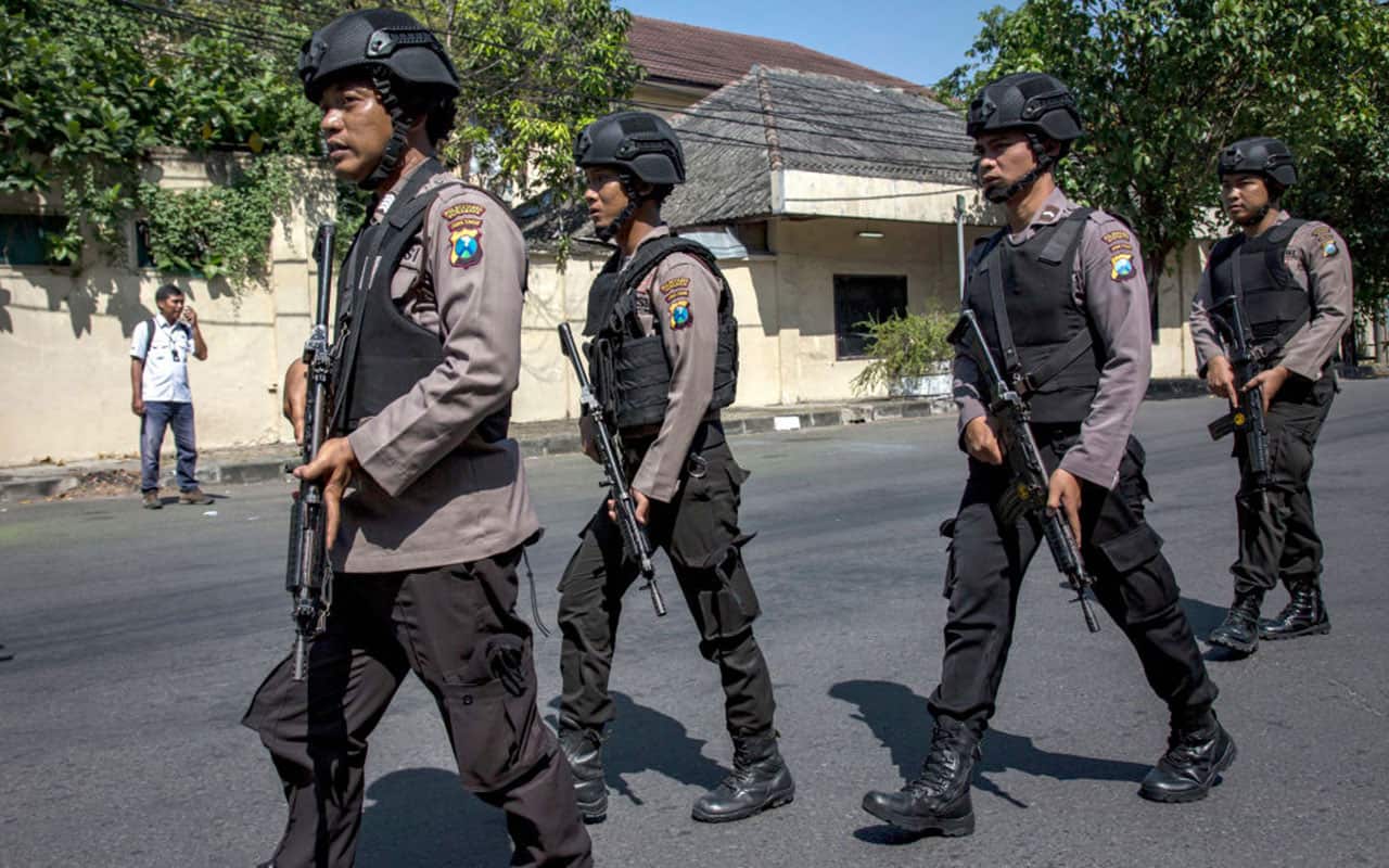 Indonesian police outside a police station in Surabaya.