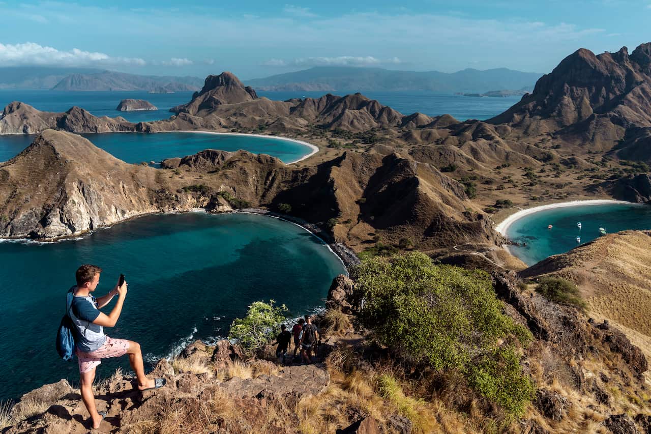 Tourists hike on Padar Island in Komodo National Park, Indonesia, July 16, 2019. (Adam Dean/The New York Times)