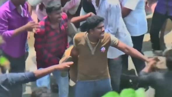 Protesters carry the injured. 