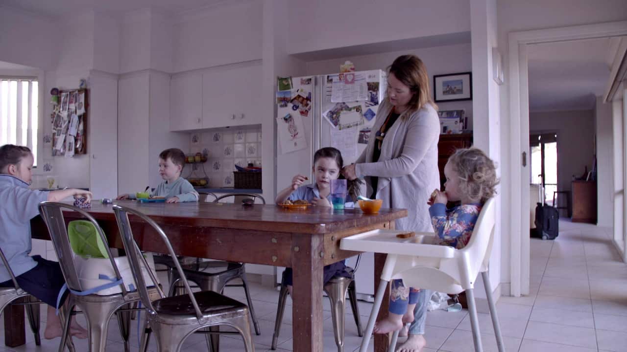 Katie Cummins helps Isabelle and her other children get ready in the morning. 