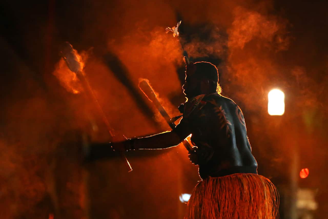 Torres Strait Islanders perform during a vigil on the eve of Australia Day, at Barangaroo.