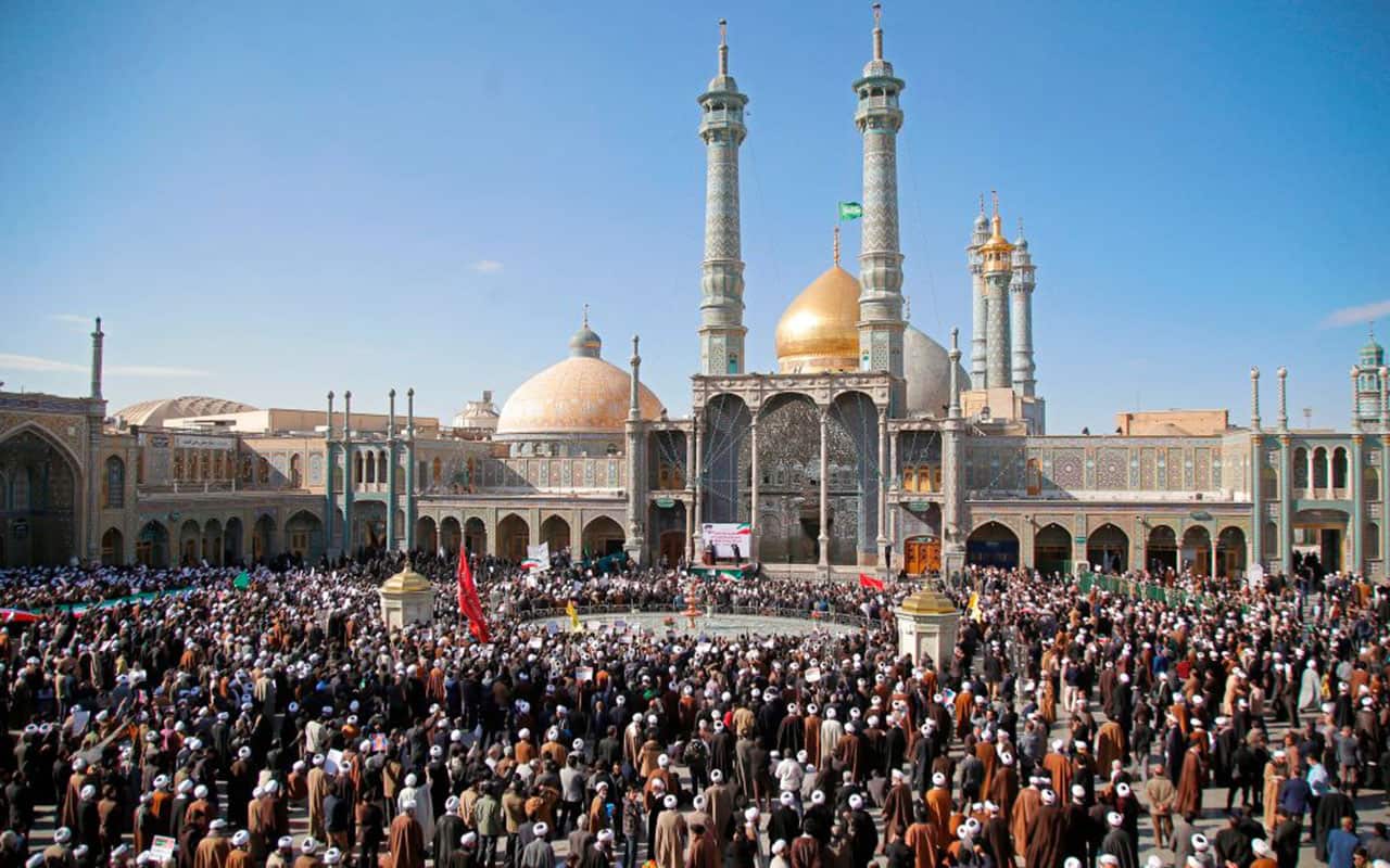 Pro-government demonstrators gather at the Massoumeh shrine in Iran's holy city of Qom, some 130 kilometres south of Tehran on January 3, 2018,