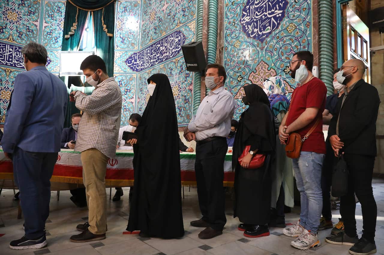 Voters queue at a polling station during the presidential elections in Tehran, Iran.