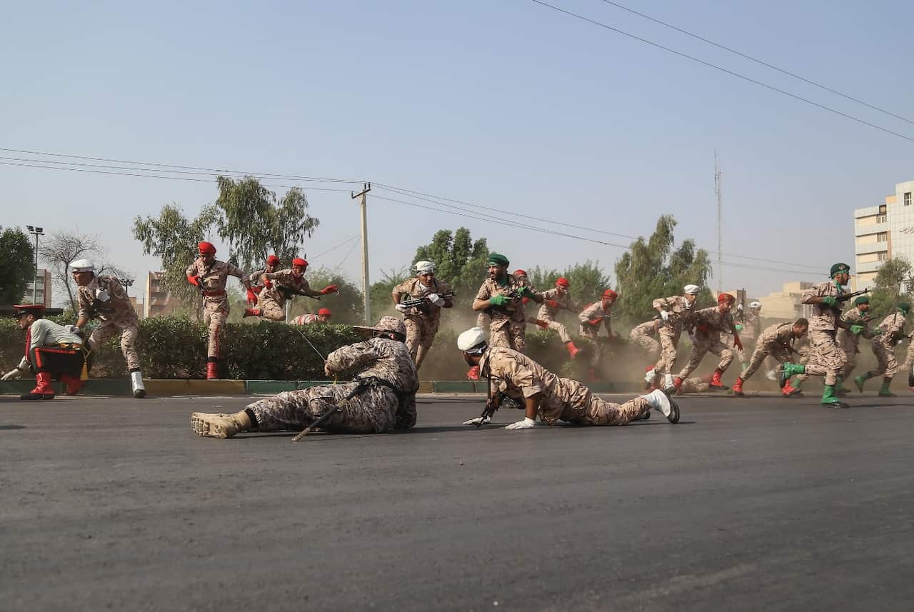 Iranian soldiers, women, and children lay down and run during a terror attack that occurred at military parade in the city of Ahvaz, southern Iran