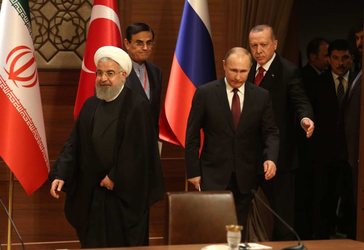 Iran's President Hassan Rouhani, left, Russia's President Vladimir Putin, right, and Turkey's President Recep Tayyip Erdogan