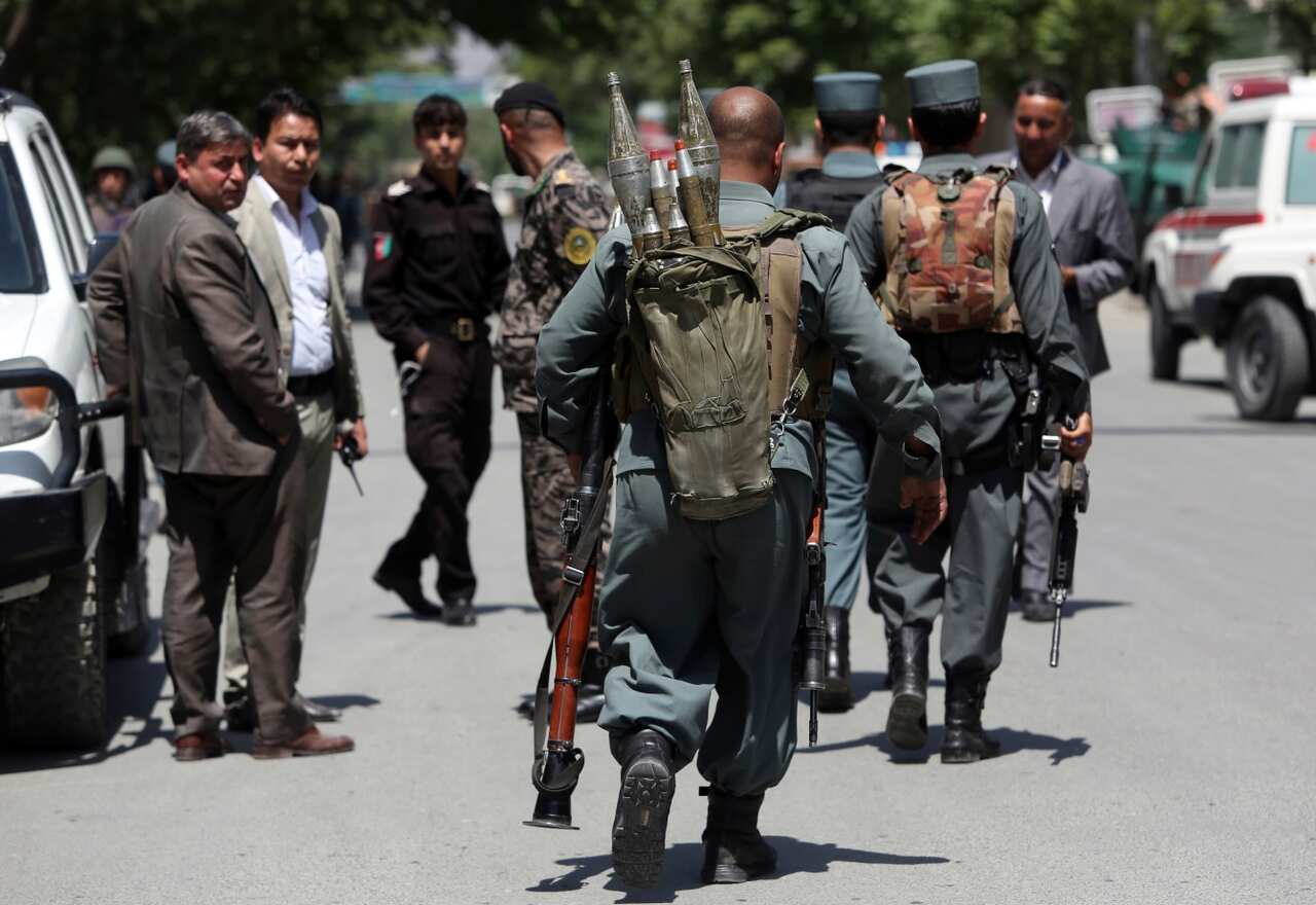 Afghan security personnel inspect at the site of a suicide attack, in the center of Kabul, Afghanistan, Wednesday, May 9