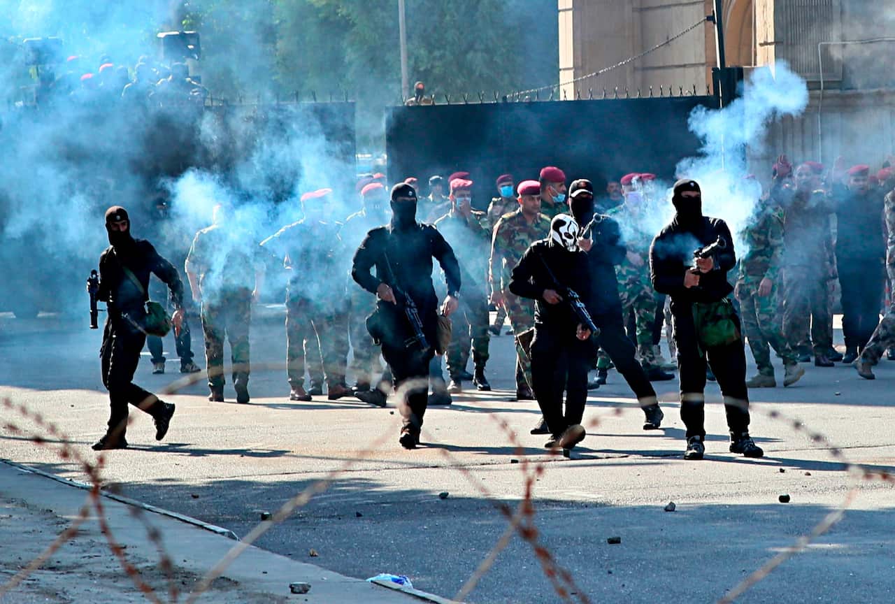 Iraqi security forces fire tear gas to disperse anti-government protesters in central Baghdad, Iraq.