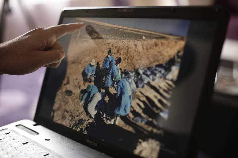 Sirwan Jalal, Director of Mass Graves for the Kurdish Regional Government, points to an image of the site of a mass grave.