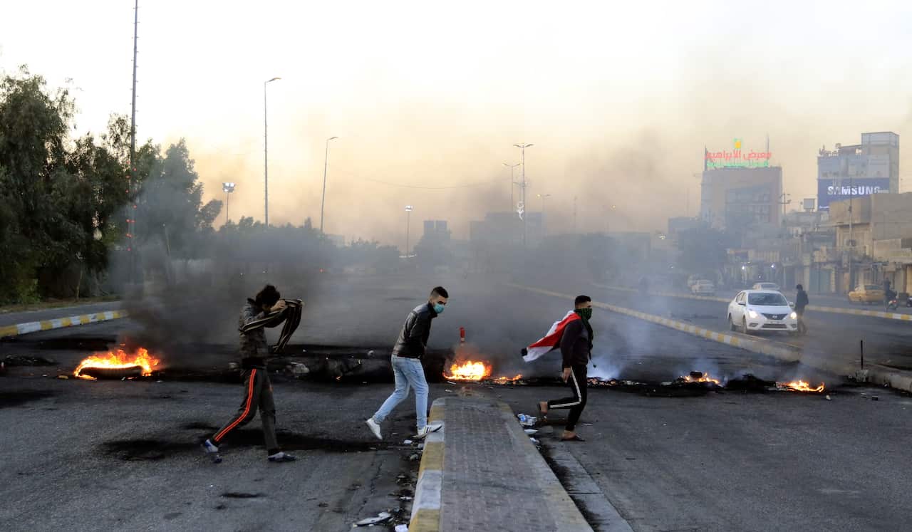 Demonstrators burn tires to close a way in central Karbala city, southern Iraq.