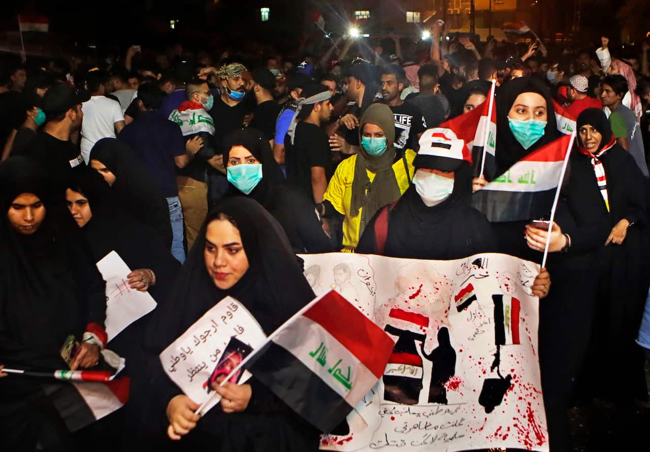 Anti-government protesters gather near Basra provincial council building during a demonstration in Basra, Iraq.