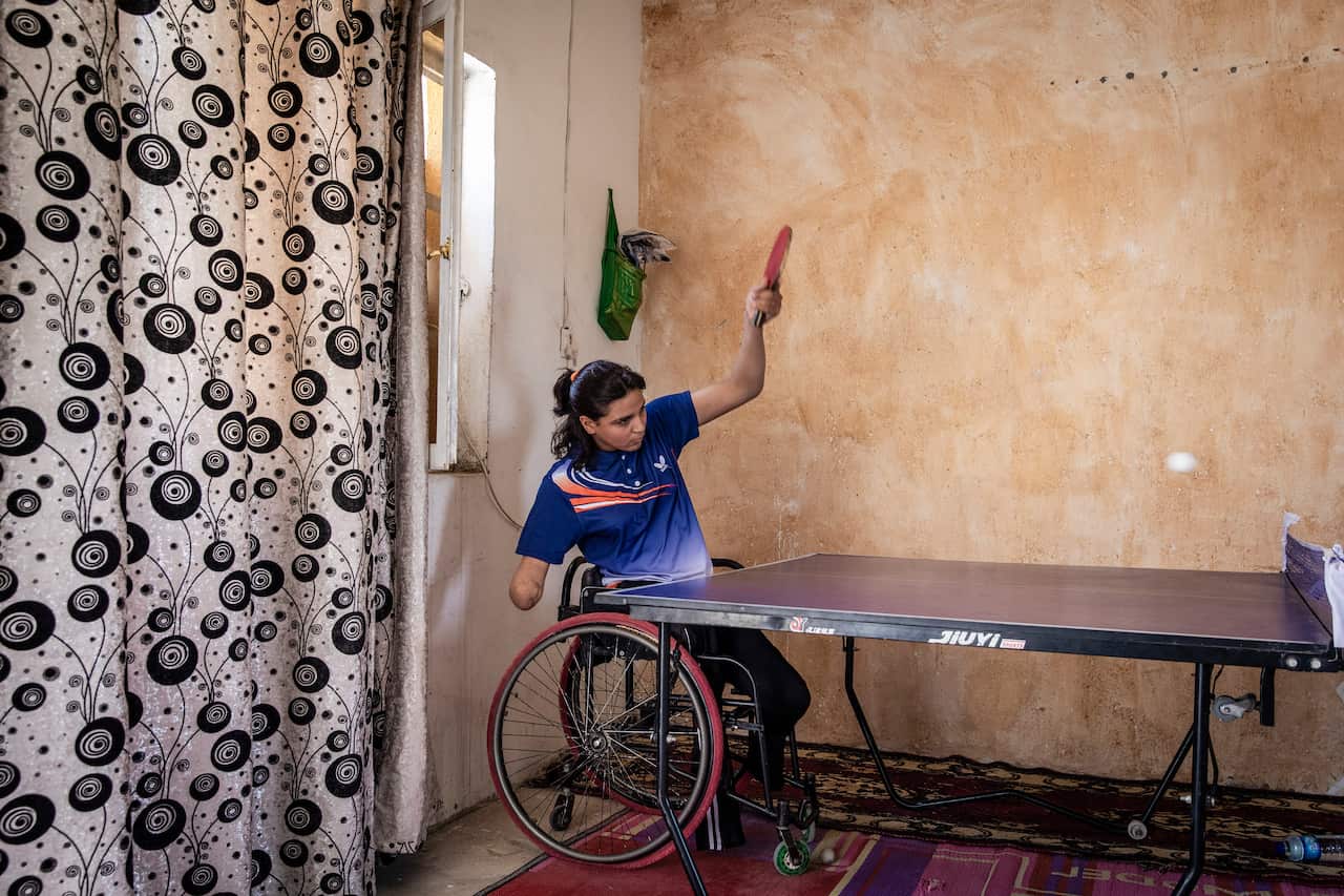 Najla Imad Lafta, a triple amputee and member of the Iraqi Paralympic Table Tennis team, trains with her coach, Hossam Hussein al-Bayat, at her home in Baqubah, Iraq, June 14, 2019. (Ivor Prickett/The New York Times)