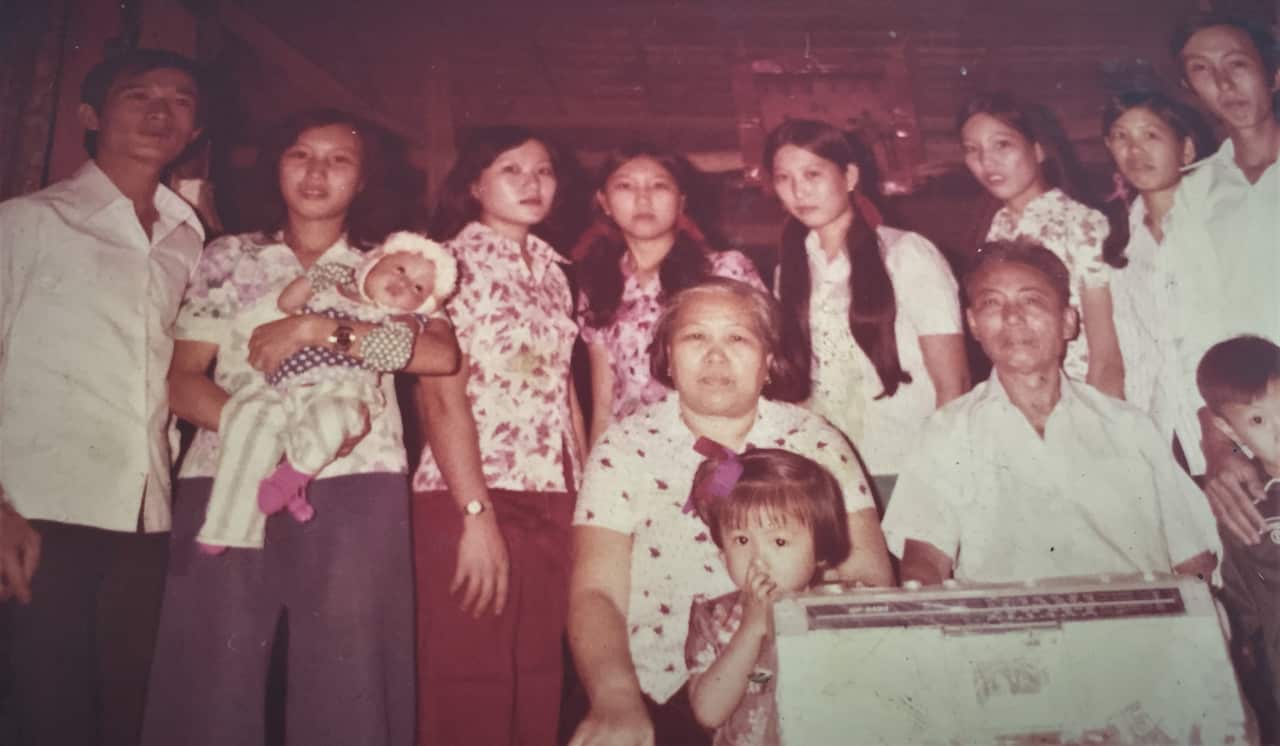 Iris (centre front) with her extended family in Cambodia.