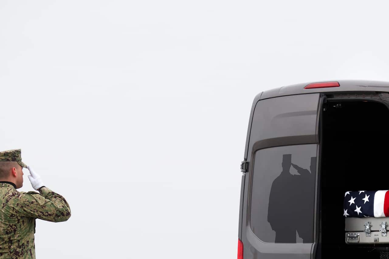 A military serviceman salutes the remains of Scott A. Wirtz, one of four Americans killed in an Islamic State group attack in Manbij, Syria, at Dover Air Force Base in Delaware, on Jan. 19, 2019. (Tom Brenner/The New York Times)