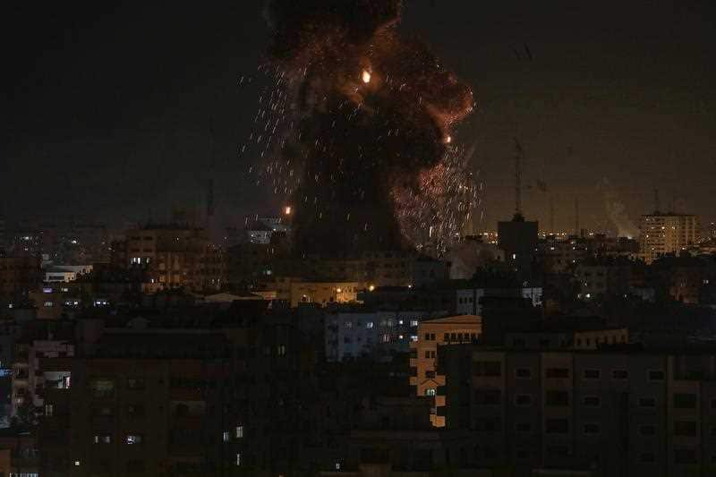 Smoke rises from the destroyed TV station after the Israeli strike.
