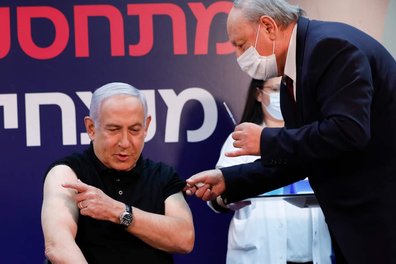 Israeli Prime Minister Minister Benjamin Netanyahu gets ready to receive a coronavirus vaccine at Sheba Medical Center on 19 December 2020. 