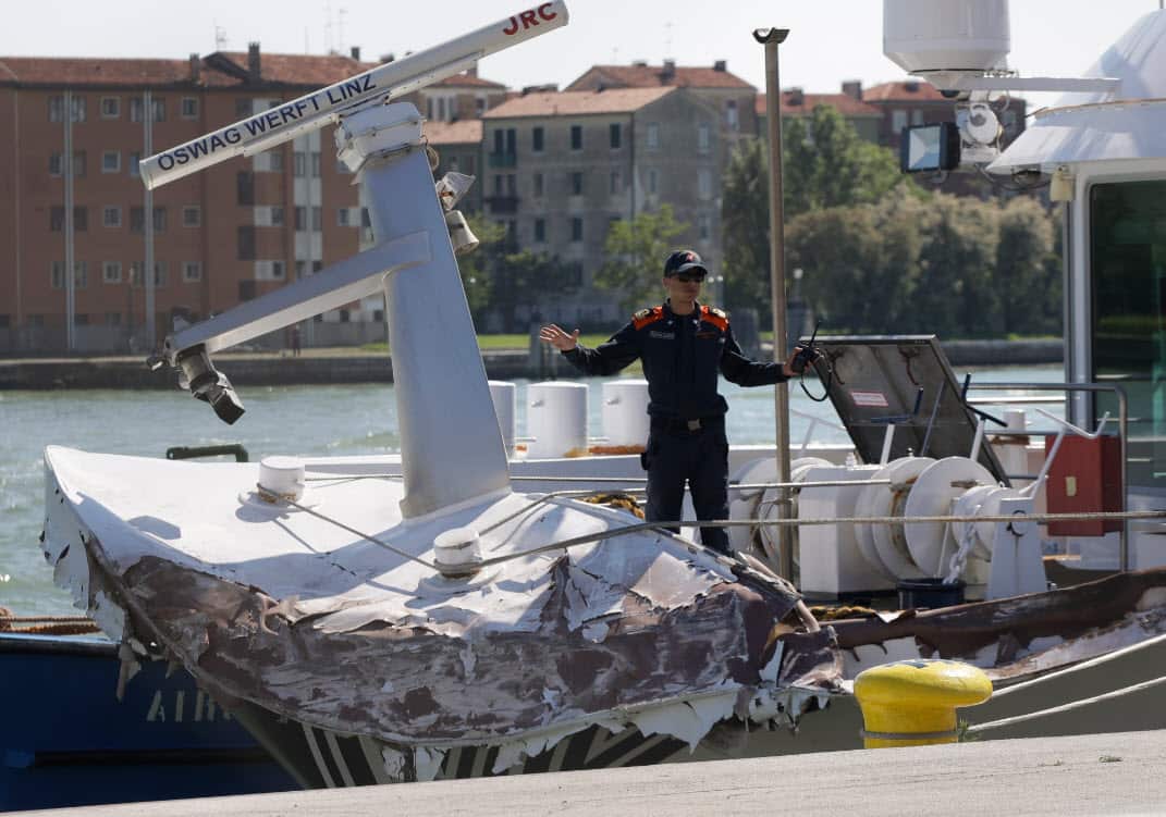 Italian Coast Guard officers inspect the tourist boat that was struck by a cruise line ship in Venice, Italy, Sunday, June 2, 2019 (AAP)