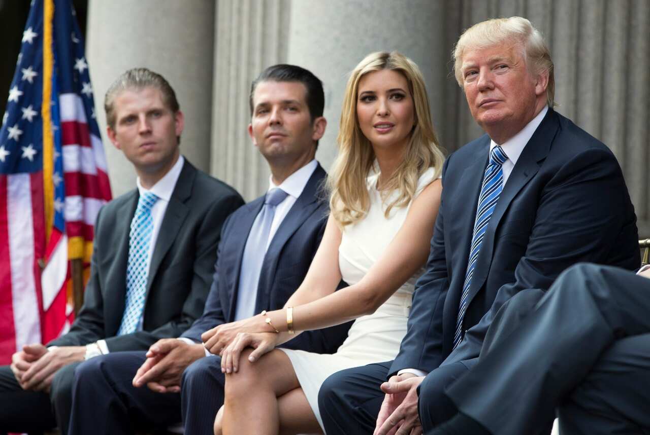 2014 file photo, Donald Trump, right, sits with his children, from left, Eric Trump, Donald Trump Jr., and Ivanka Trump 