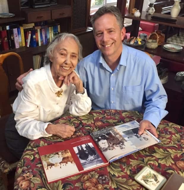 Ivy Anderson and son Keith looking at early family photos from Labrador.