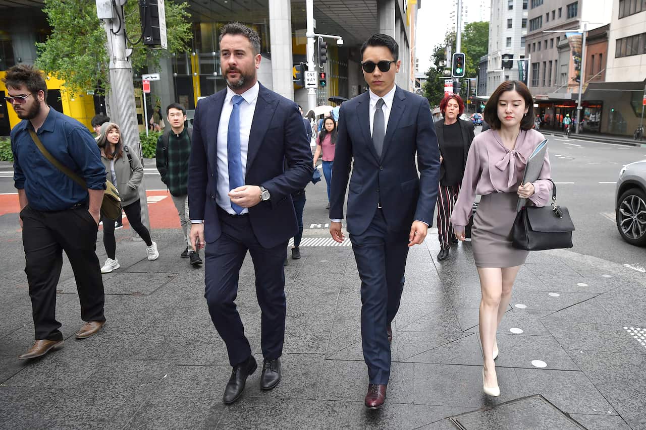 Yunxiang Gao (centre) arrives at the Downing Centre District Court in Sydney.