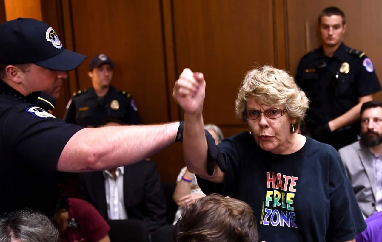 A protester shouts during a hearing of the Senate Judiciary Committee on the nomination of Brett Kavanaugh