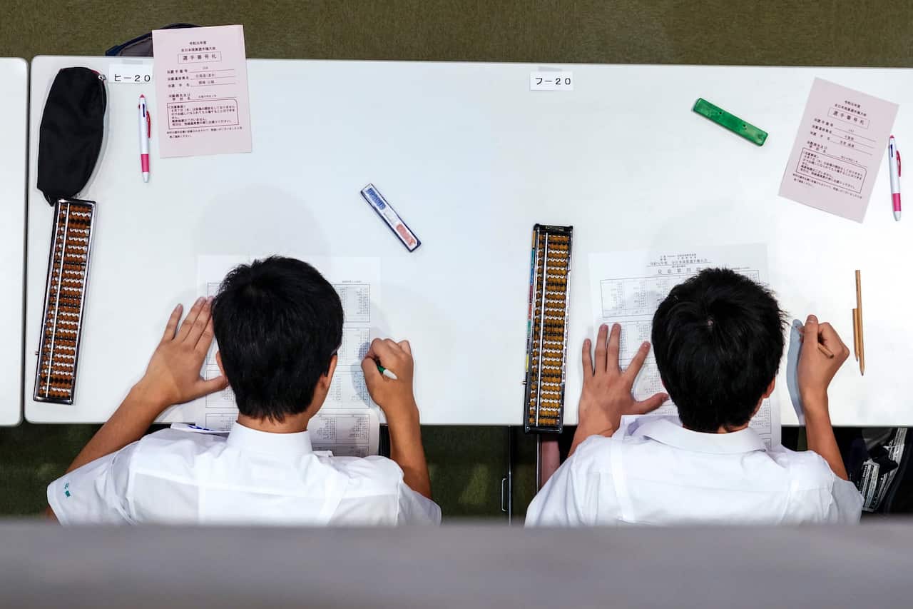 Students concentrating on their calculations in Kyoto, Japan, Aug. 8, 2019. (Chang W. Lee/The New York Times)
