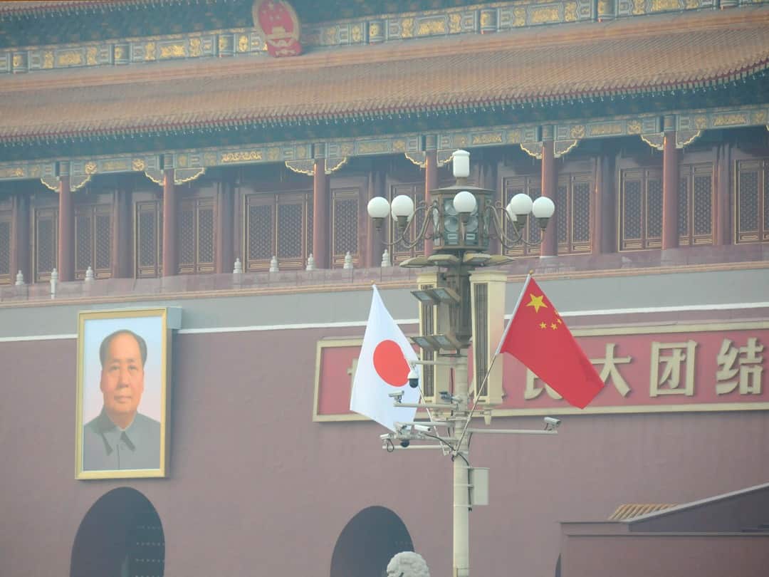 Chinese and Japanese national flags flutter on the lamp post in front of the Tian'anmen during the three-day official visit.