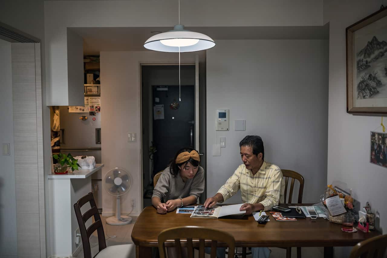 At his home in Tokyo in August 2018, Jiro Oshima and his granddaughter Misa An look through old photo albums of his trips to visit family in North Korea. 