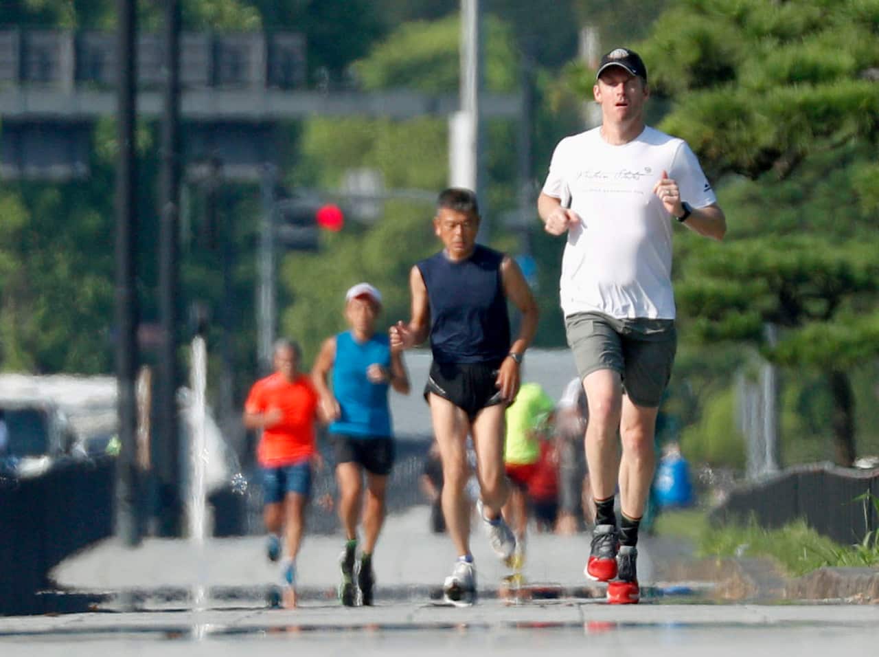 People run in a heat haze near the Imperial Palace in Tokyo in the morning of Aug. 2, 2018, with the mercury exceeding 35 C in many parts of Japan.