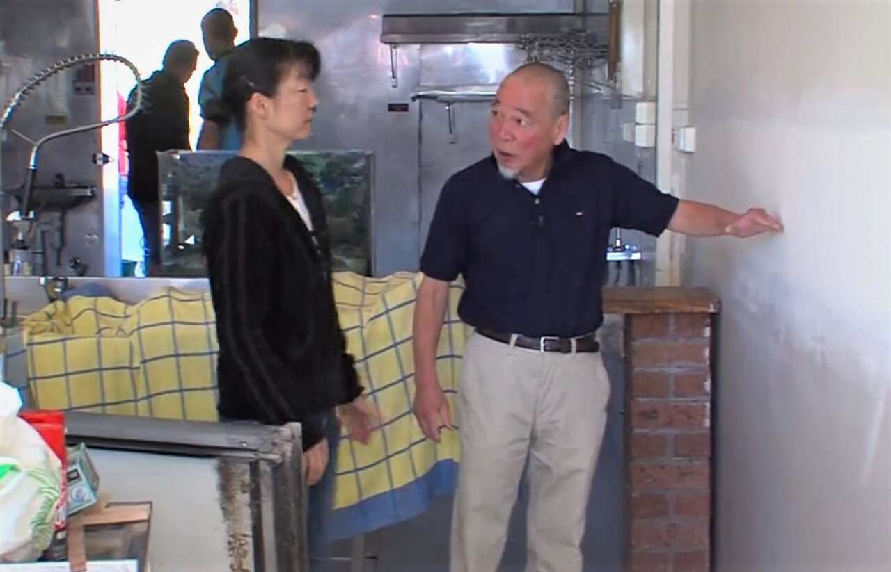 Koichi Sato shows the height of the food water.