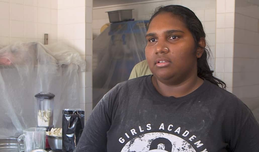 Jaylene Lawford helps her uncle Robert Dann to process boab tree nuts.