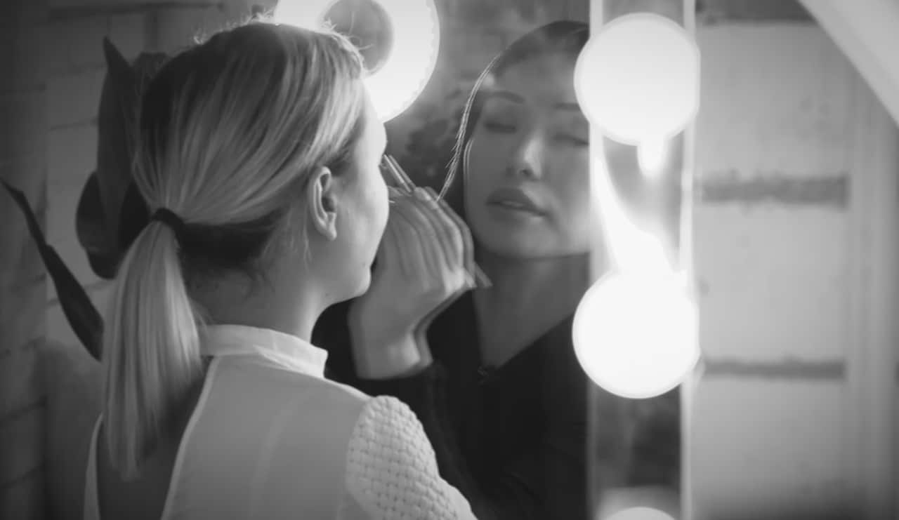 Jenny Do applying makeup to a client at her studio.