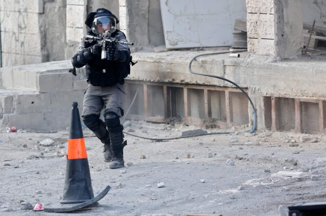 An Israeli police officer takes aim during clashes near the Qalandia checkpoint between Jerusalem and the West Bank city of Ramallah.