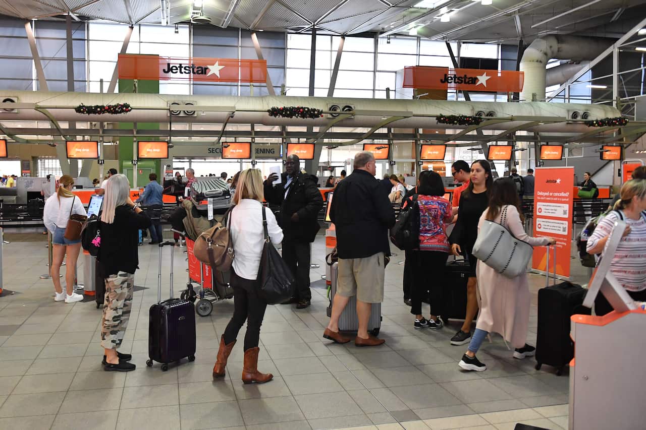 Passenger wait at the Jetstar check in counters at Sydney Domestic Terminal last week as delays mounted during the four-hour work stoppage by workers.