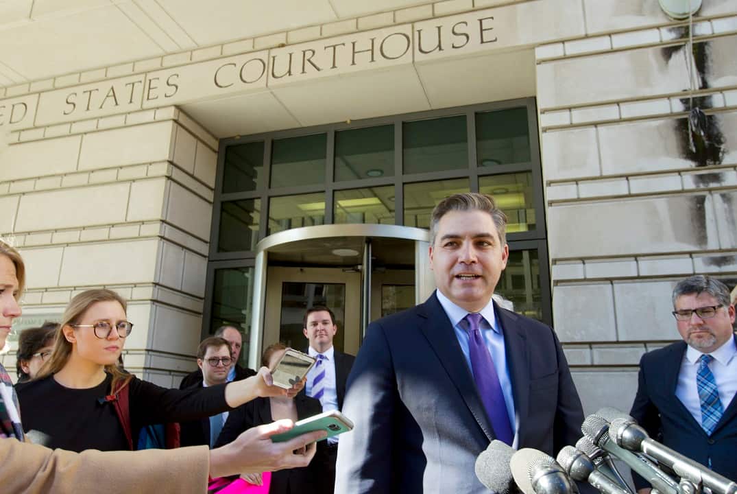 CNN reporter Jim Acosta speaks with reporters outside of the US District courthouse.