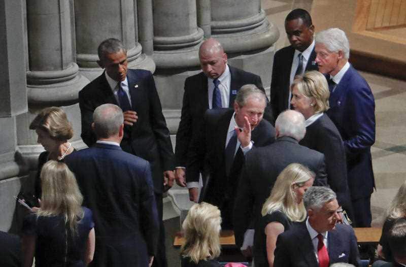 Mourners, including former US presidents Barack Obama and George W. Bush at the church.