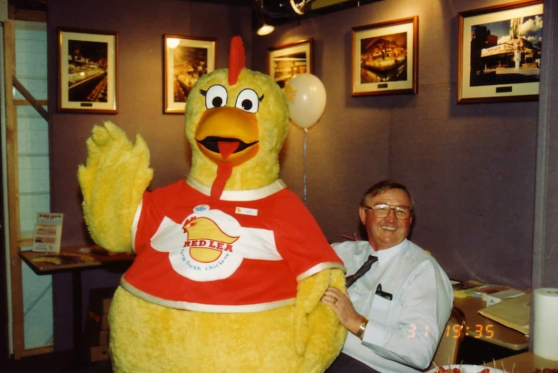 The Redlea mascot and founder celebrate a 1990's store opening.