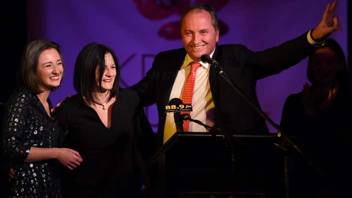 Barnaby Joyce, alng with his wife Natalie and daughters, gestures as he claims victory for the seat of New England in 2016.