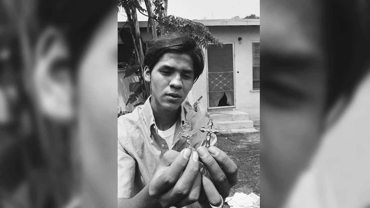 Juan Romero holds crucifixes sent to him to replace the Rosary which he gave to the Senator.