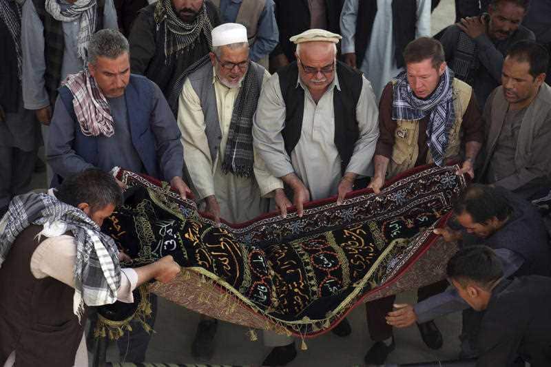 Men carry the coffin of a relative who died in Wednesday's deadly suicide bombing