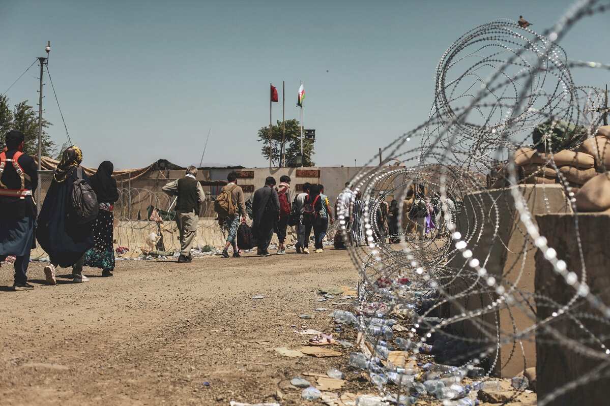 Evacuees wait to be processed at Hamid Karzai International Airport on 25 August 2021.