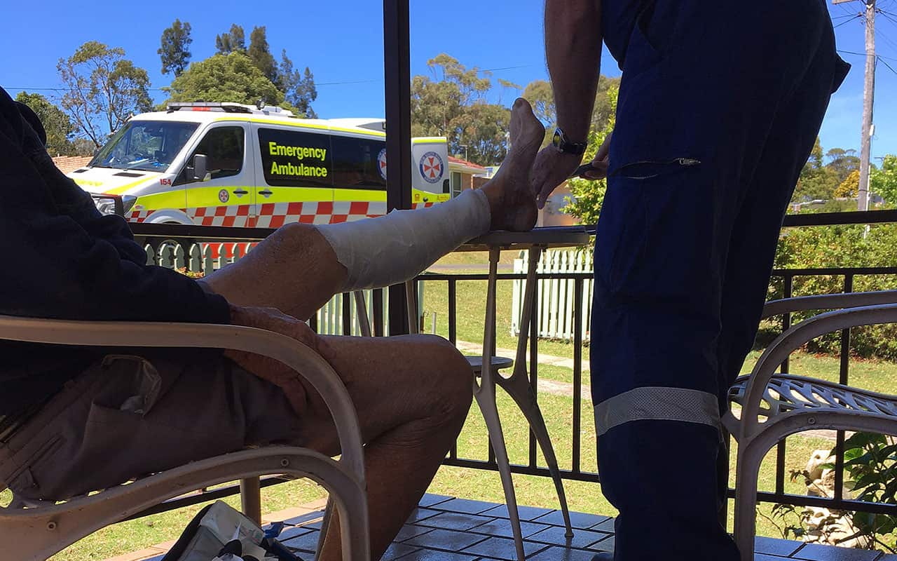 Supplied image of NSW Ambulance paramedics treating an 80-year-old man after he was attacked by a kangaroo at Bendalong on the NSW South Coast.
