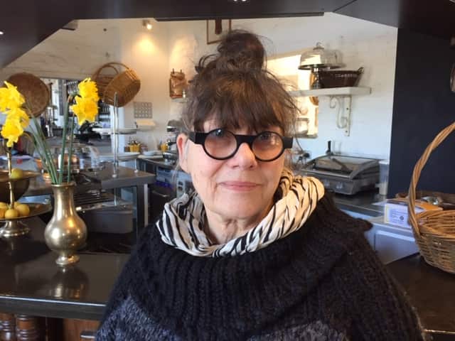 Karen Blomquist from Elephant Bridge Hotel serves Caravan Eggs to her customers.