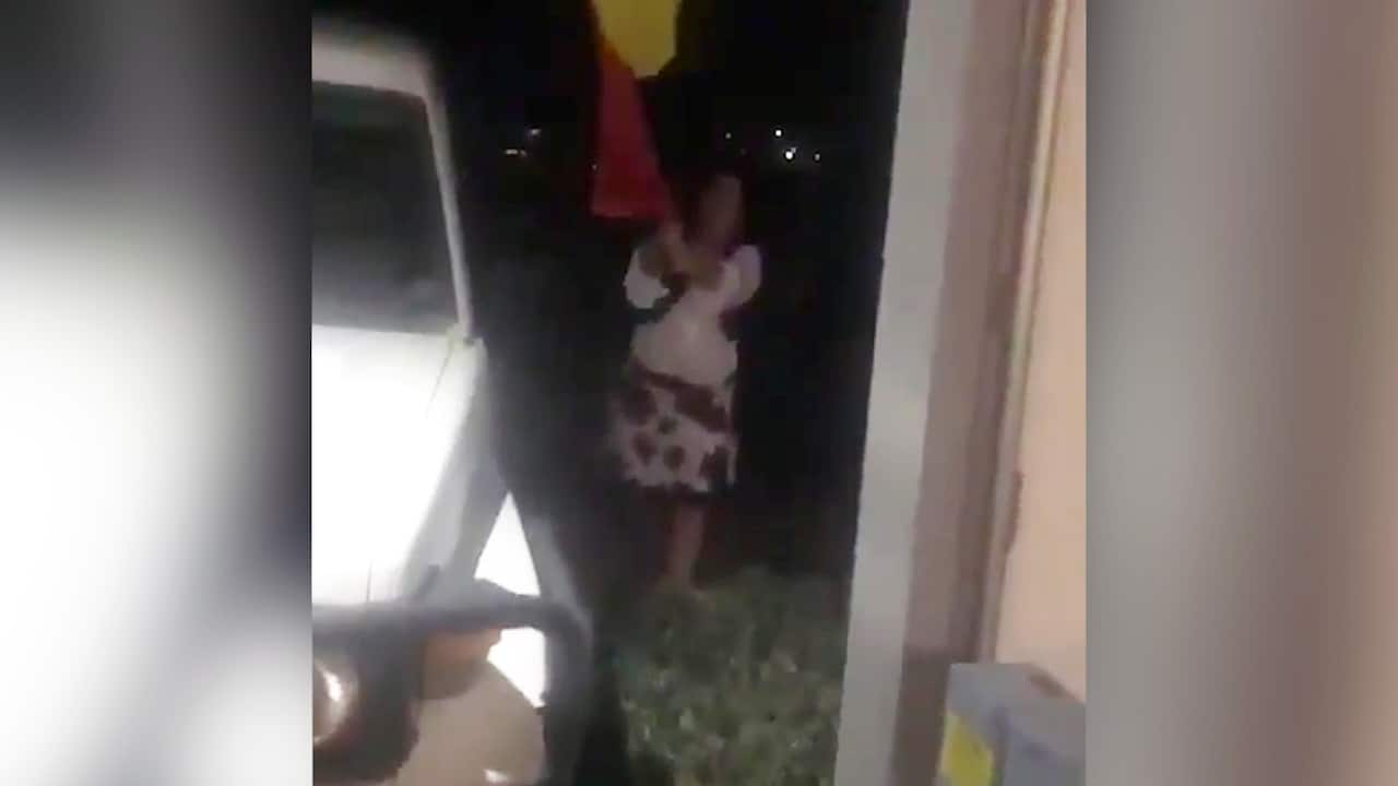 Karen (pictured) trying to tear down an Aboriginal flag on a Mildura property.