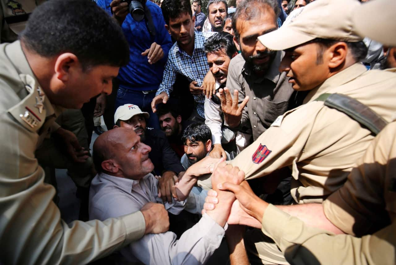 Indian Police officers detain an independent Kashmir lawmaker, Abdul Rashid Sheikh during a protest march in Indian Kashmir on Sept 26