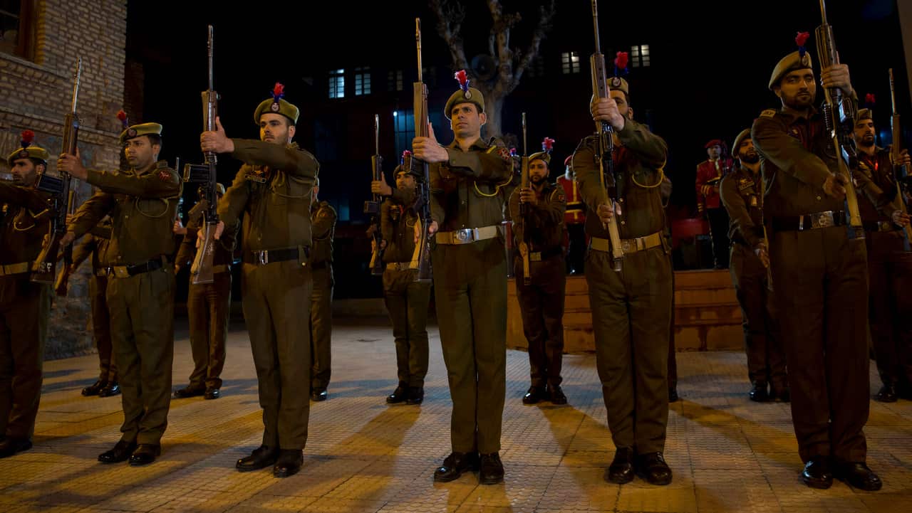 Indian policemen pay homage during the wreath-laying ceremony of their colleague in Srinagar, Indian controlled Kashmir.