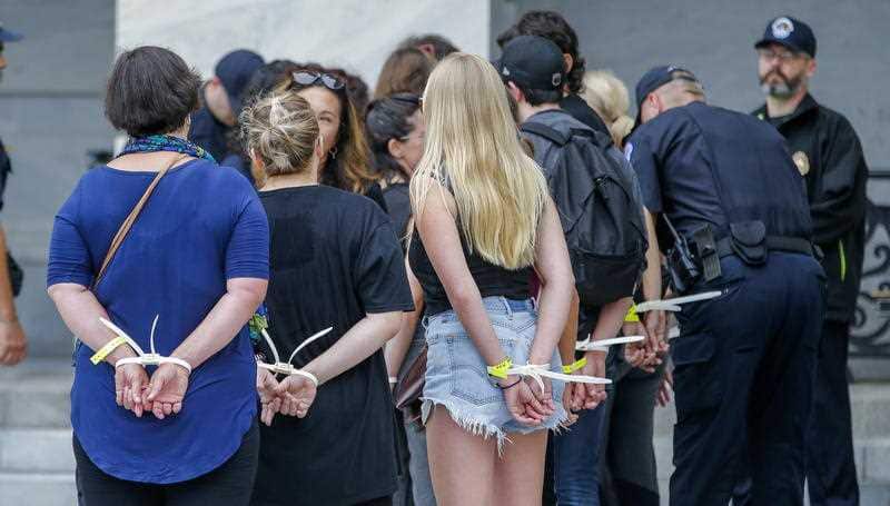 Police arrest protesters.