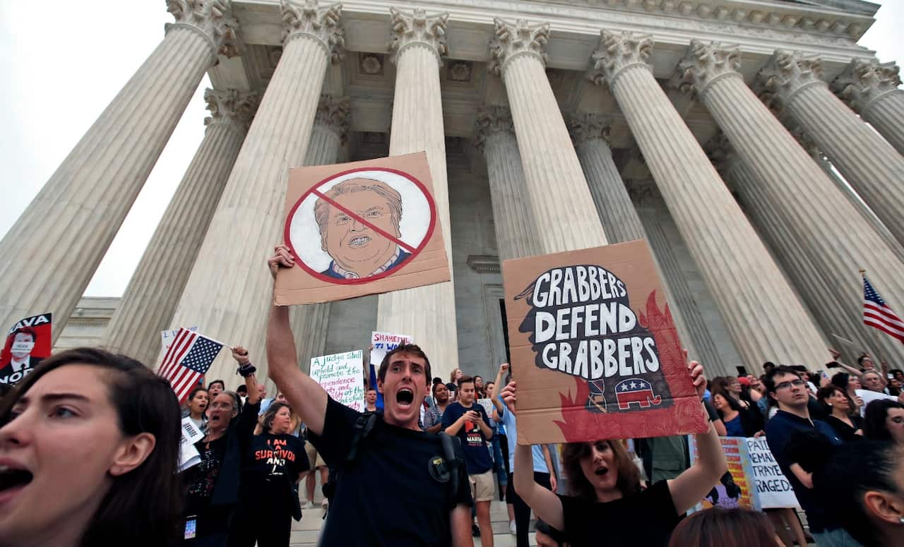 People protest on the steps of the Supreme Court after the confirmation vote of Supreme Court nominee Brett Kavanaugh